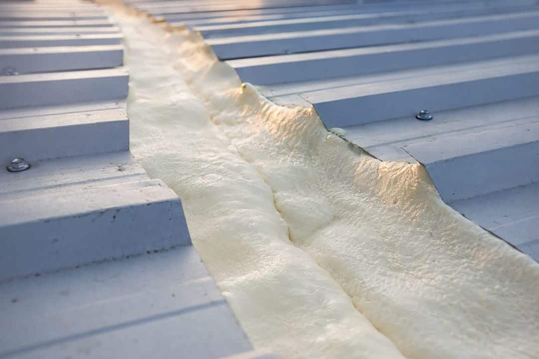 Seamless spray foam insulation on metal roof joint